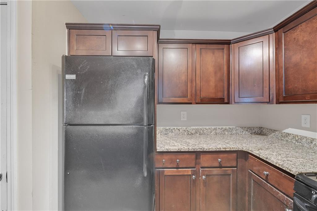 55 Wyman Street Southeast Atlanta, GA 30317 - Photo 7 of 25 a kitchen with granite countertop cabinets and refrigerator