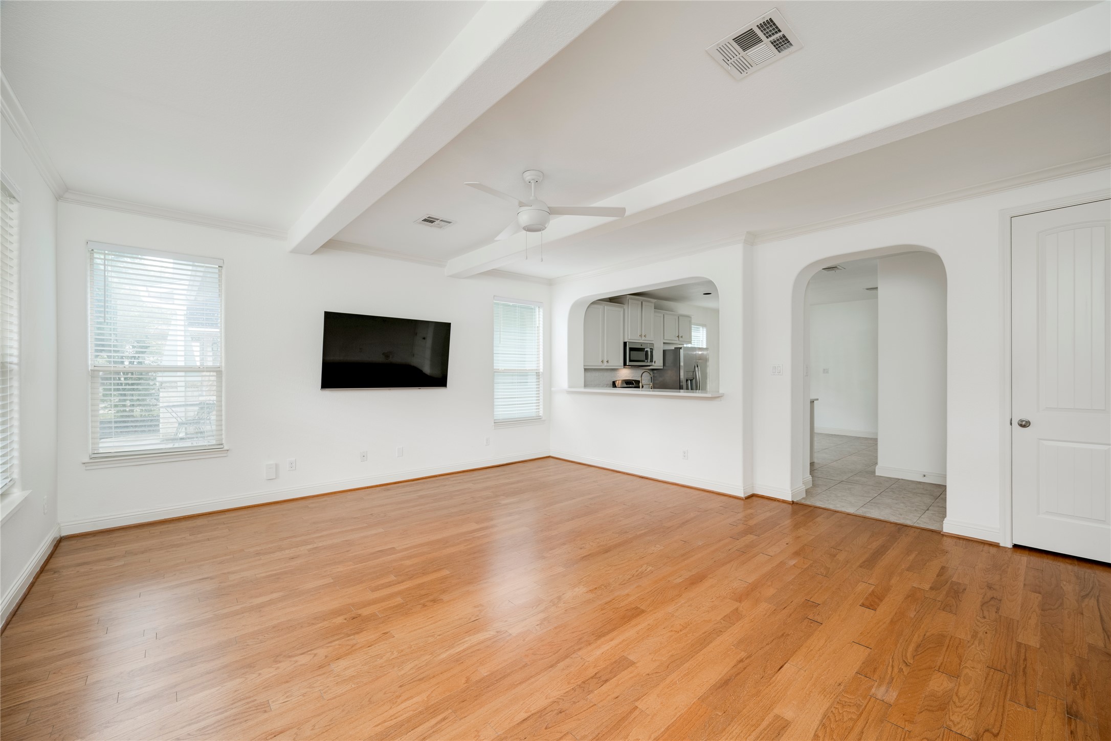 6008 Whipple Way Austin, TX 78745 - Photo 5 of 39 Sun-filled living space offers gleaming hardwood floors and convenient kitchen pass-through.