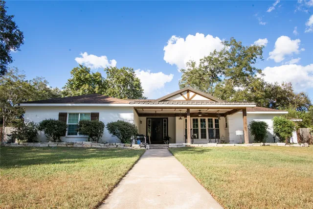 a view of house that has a swimming pool with a patio