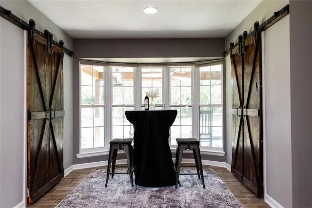 a dining room with furniture and a window