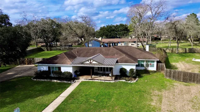 a aerial view of a house with a yard