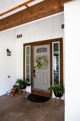 a front view of a house with potted plants