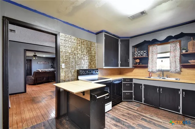 a kitchen with a sink and cabinets