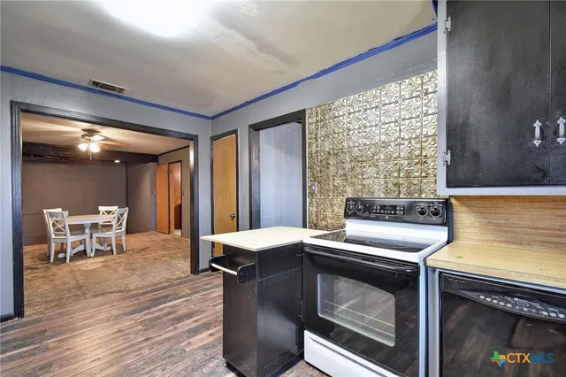 a kitchen with a stove and a table