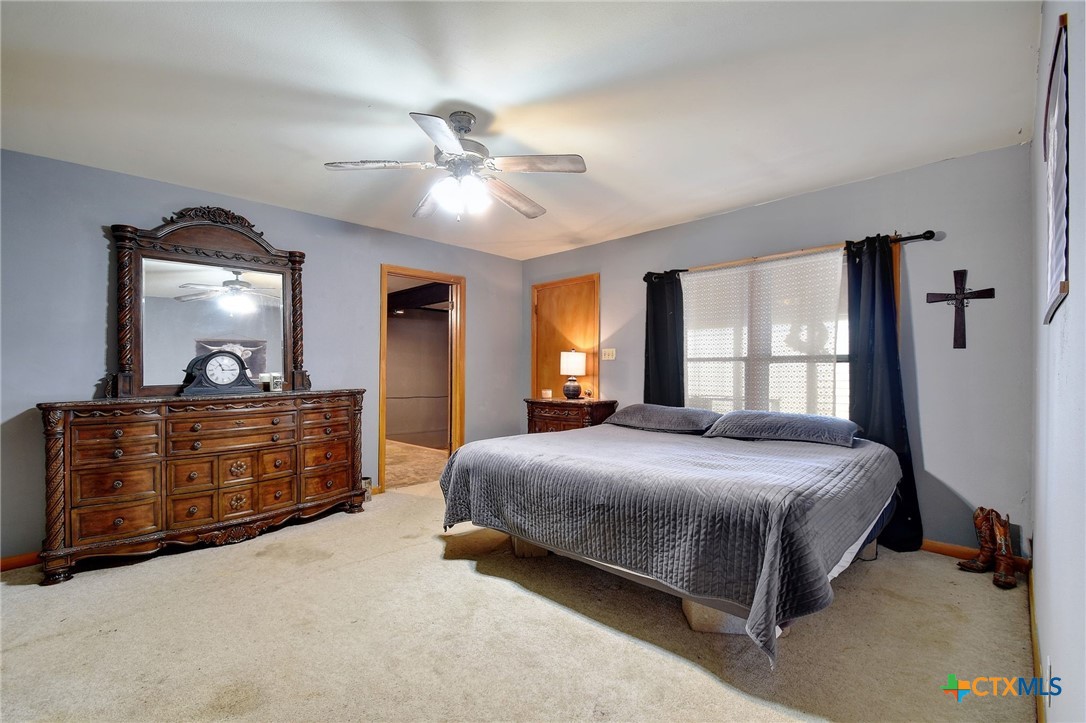 1017 Highway 87 Smiley, TX 78159 - Photo 15 of 30 a bedroom with a bed and dresser with mirror