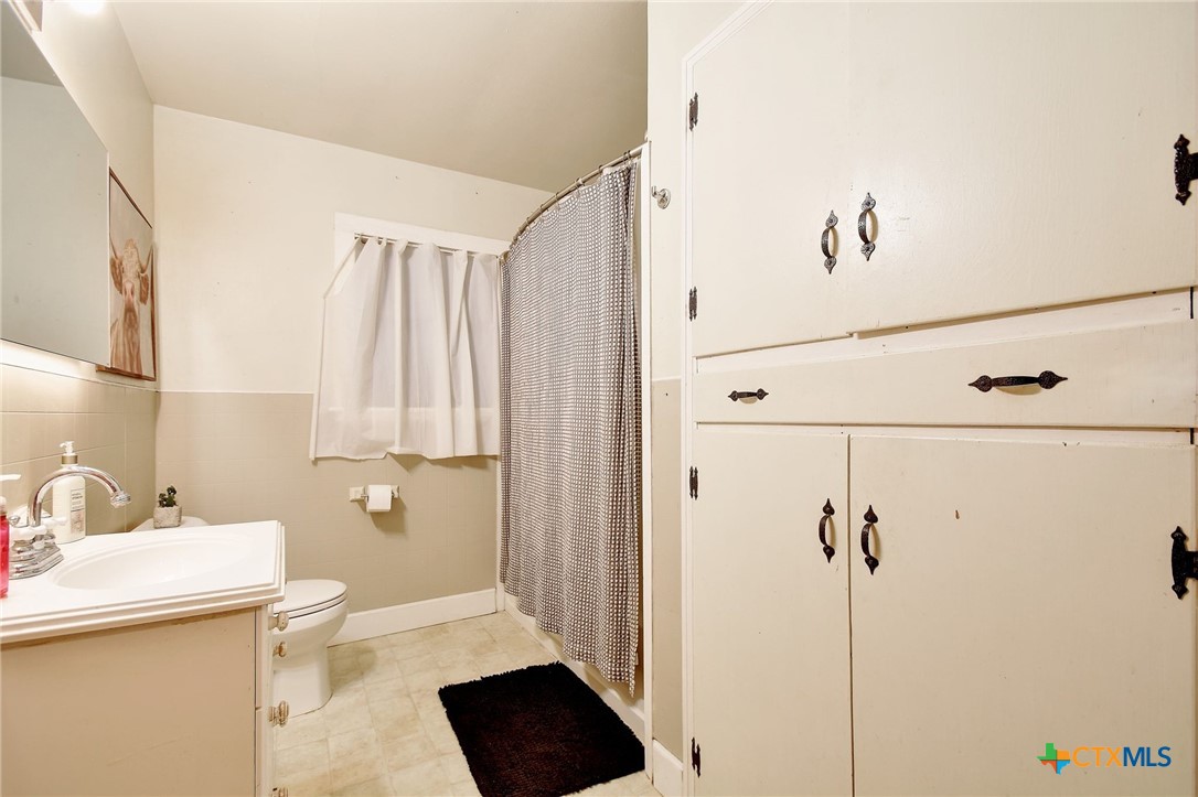 1017 Highway 87 Smiley, TX 78159 - Photo 17 of 30 a bathroom with a sink a toilet and shower