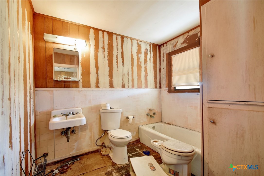1017 Highway 87 Smiley, TX 78159 - Photo 21 of 30 a bathroom with a toilet a sink and a mirror