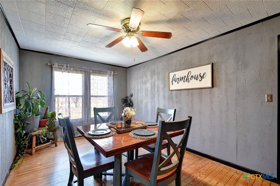 1017 Highway 87 Smiley, TX 78159 - Photo 8 of 30 a dining room with furniture a chandelier and wooden floor