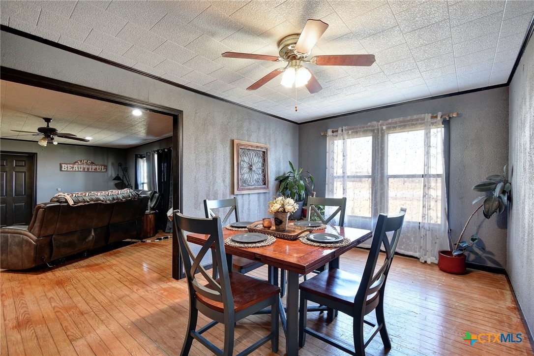 1017 Highway 87 Smiley, TX 78159 - Photo 9 of 30 a view of a dining room with furniture window and wooden floor