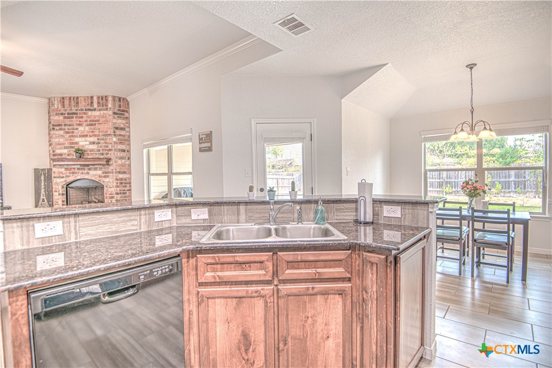 2520 Nolan Creek Street Temple, TX 76504 - Photo 32 of 32 a kitchen with granite countertop a sink and a window