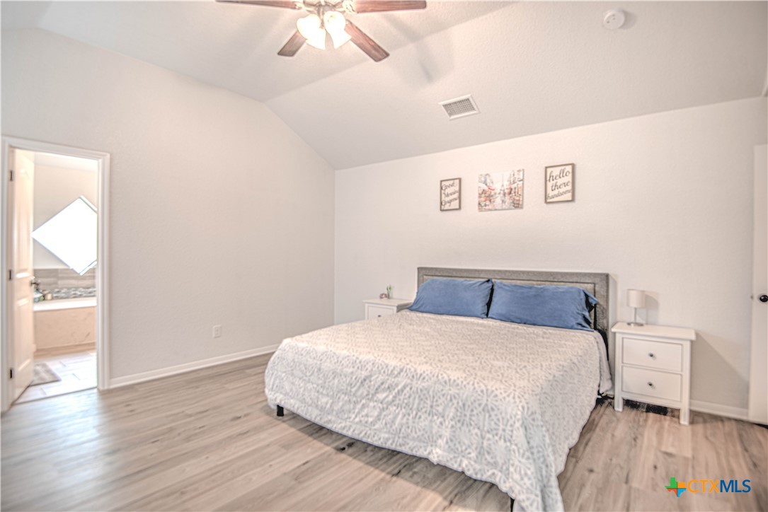 2520 Nolan Creek Street Temple, TX 76504 - Photo 15 of 32 a bedroom with a bed and a wooden floor
