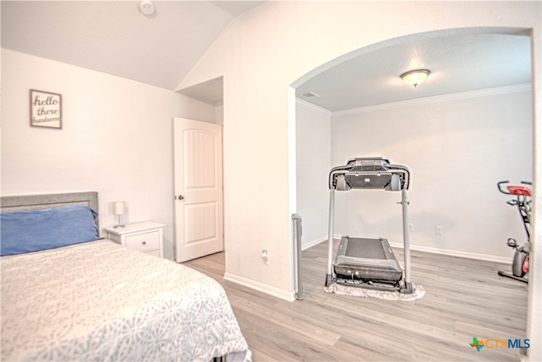 2520 Nolan Creek Street Temple, TX 76504 - Photo 17 of 32 a bedroom with a bed and wooden floor