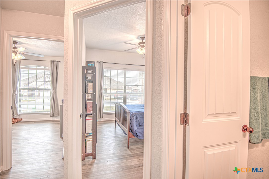 2520 Nolan Creek Street Temple, TX 76504 - Photo 21 of 32 a view of a hallway with wooden floor and windows