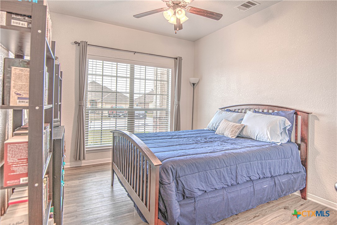 2520 Nolan Creek Street Temple, TX 76504 - Photo 22 of 32 a bedroom with a bed and a chandelier