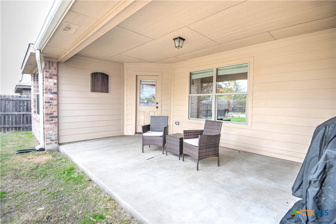 2520 Nolan Creek Street Temple, TX 76504 - Photo 27 of 32 a view of a patio with table and chairs and wooden fence