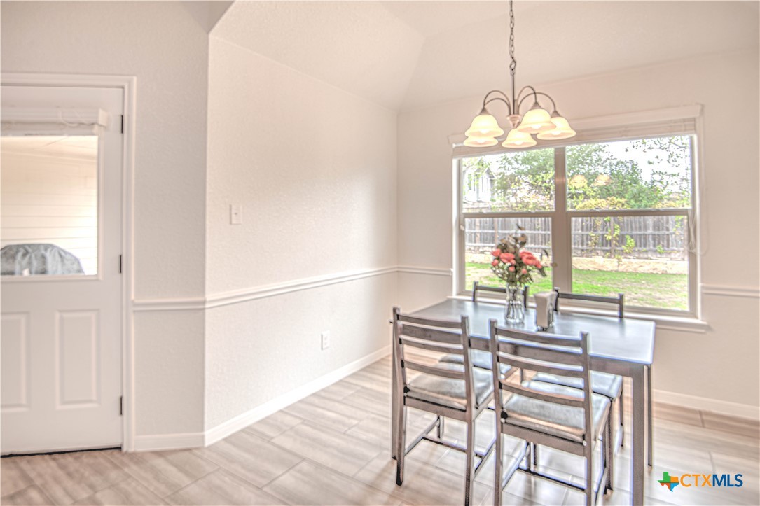 2520 Nolan Creek Street Temple, TX 76504 - Photo 8 of 32 a dining room with furniture a chandelier and a rug