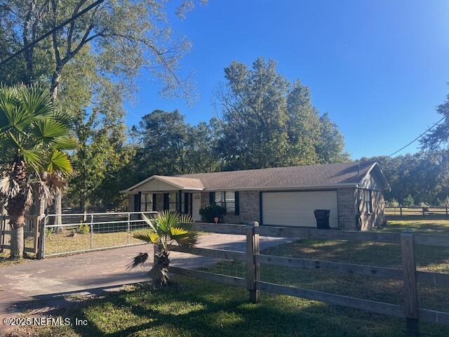 a view of a house with backyard and a tree