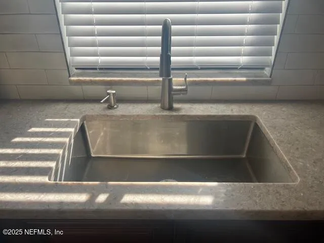 a view of a refrigerator in kitchen and stainless steel appliances wooden cabinet