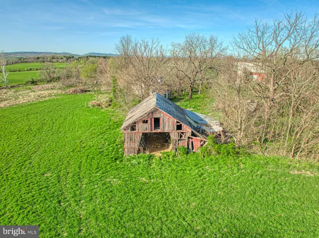 a house with green field in front of it