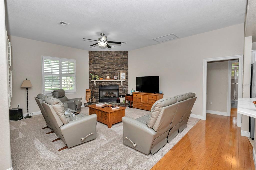 1989 Northwest 111th Loop Ocala, FL 34475 - Photo 19 of 55 a living room with furniture a flat screen tv and a fireplace
