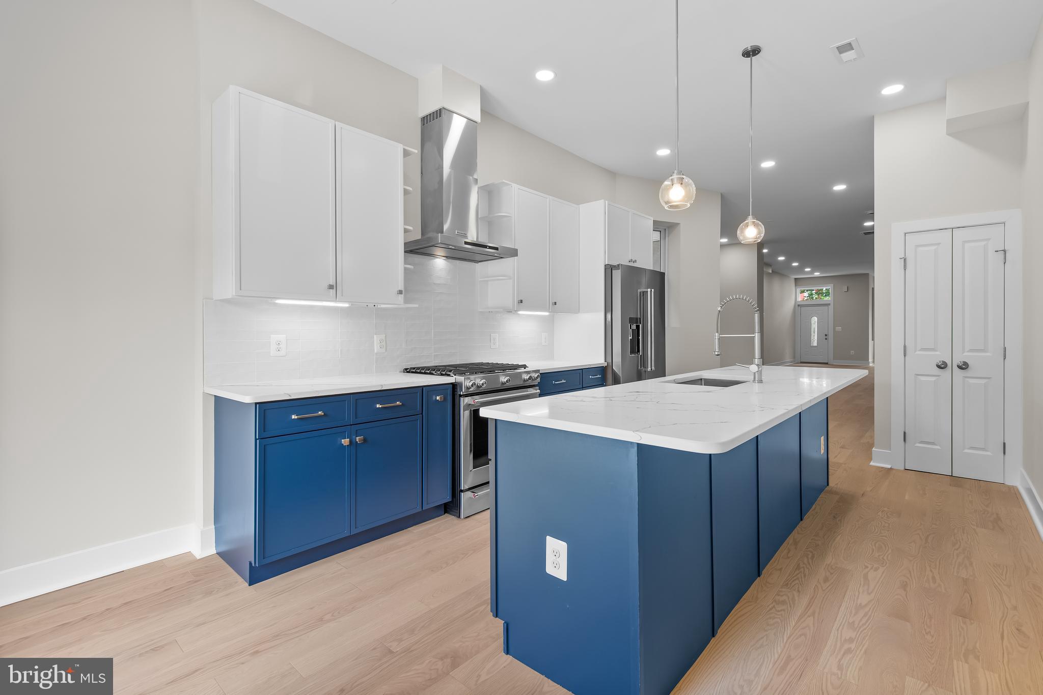 20 T Street Northwest, Unit 2 Washington, DC 20001 - Photo 11 of 31 a large kitchen with a stove a sink a refrigerator and a wooden floor