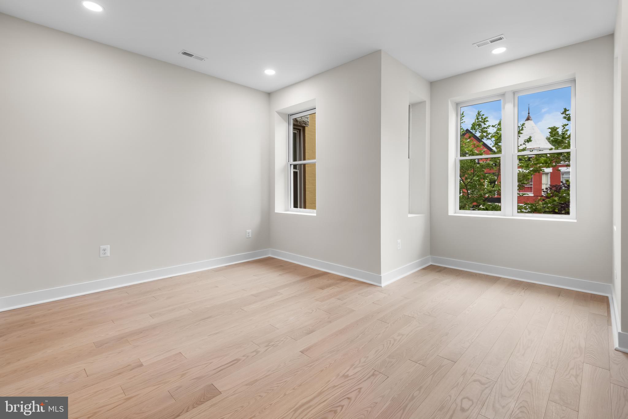 20 T Street Northwest, Unit 2 Washington, DC 20001 - Photo 19 of 31 a view of an empty room with a window and wooden floor