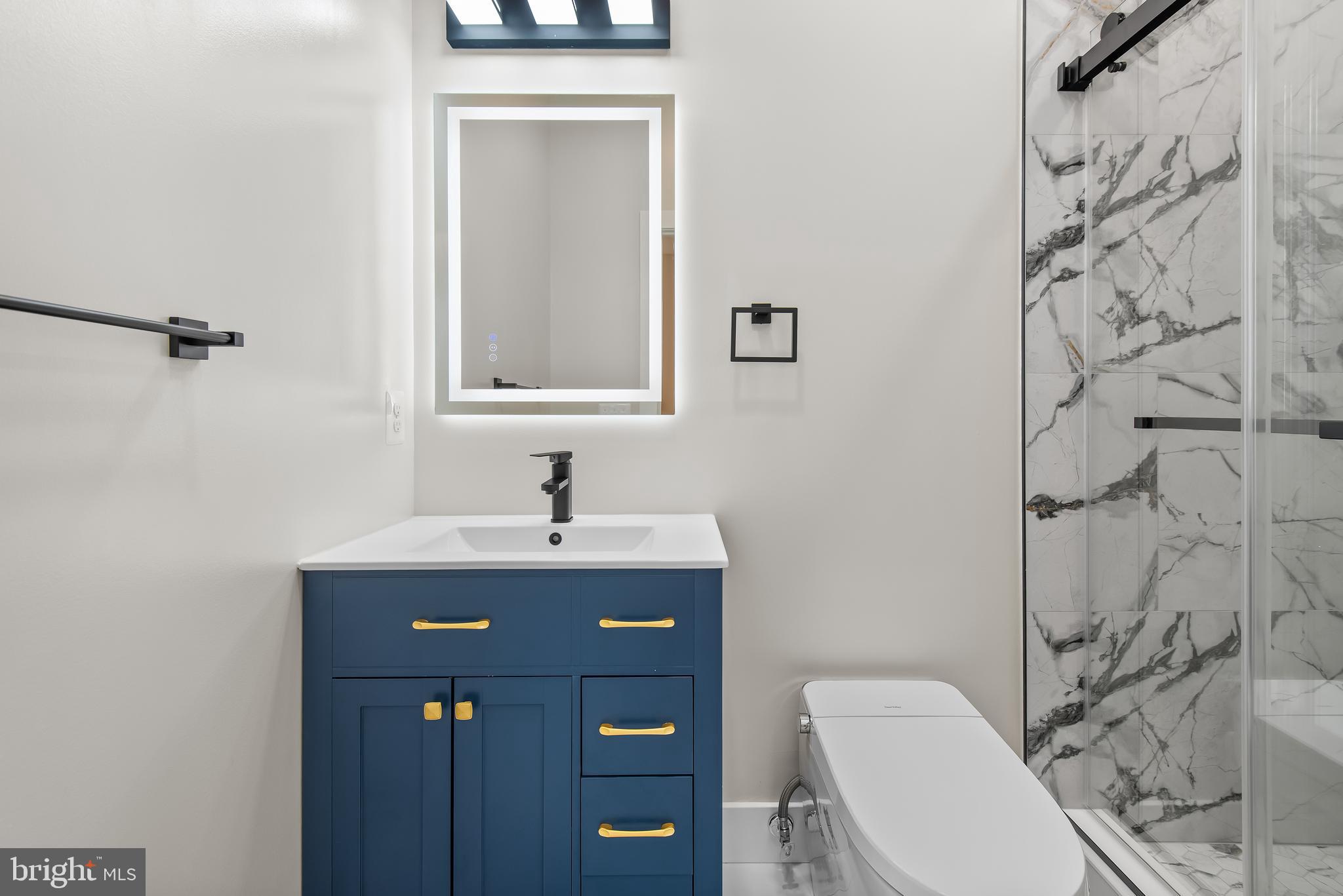 20 T Street Northwest, Unit 2 Washington, DC 20001 - Photo 22 of 31 a bathroom with a toilet a sink and mirror