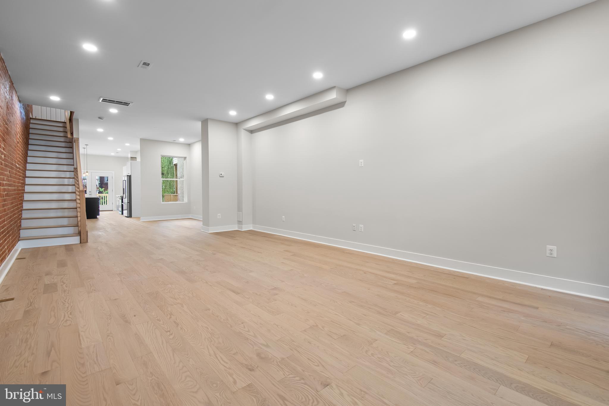20 T Street Northwest, Unit 2 Washington, DC 20001 - Photo 4 of 31 an empty room with wooden floor and windows