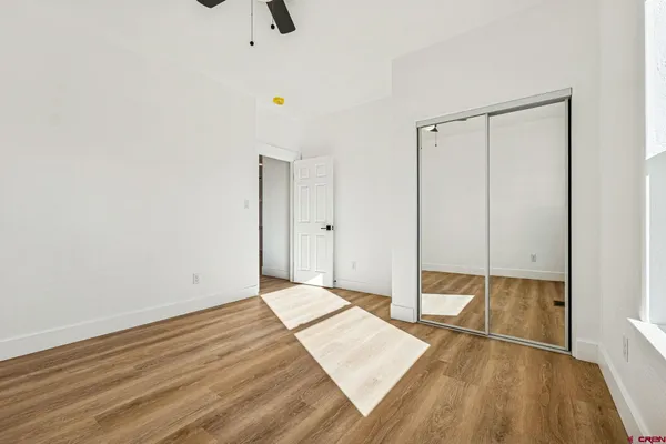 a view of a room with wooden floor