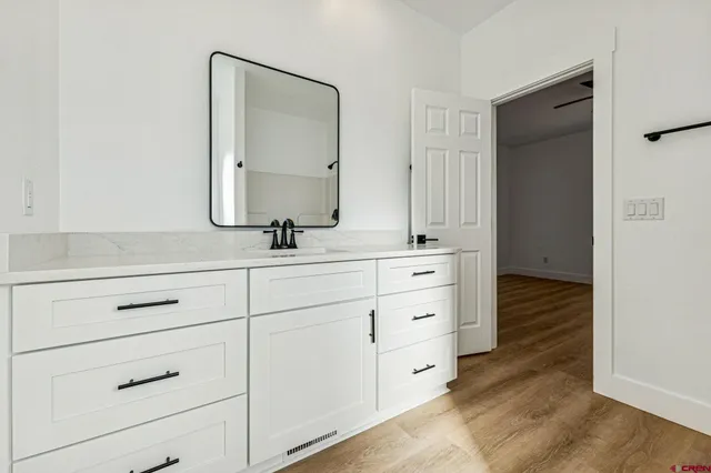 a bathroom with a sink vanity and mirror
