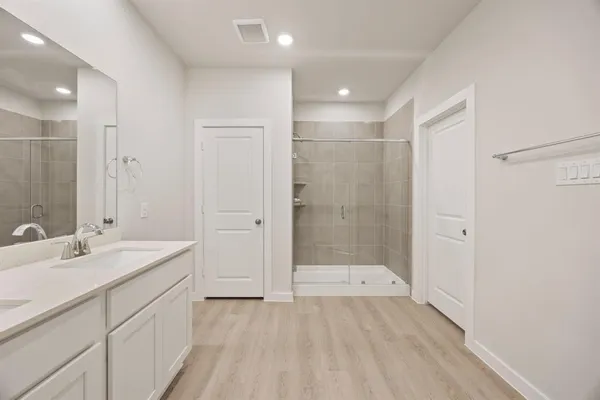 a bathroom with a sink double vanity and a mirror