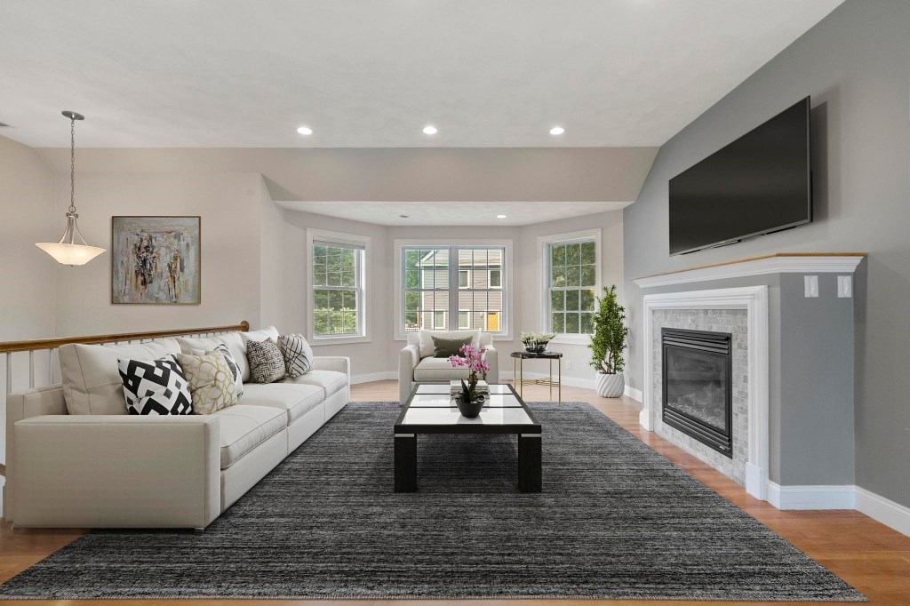 10 Emerald Court Stoneham, MA 02180 - Photo 11 of 42 a living room with furniture fireplace and flat screen tv