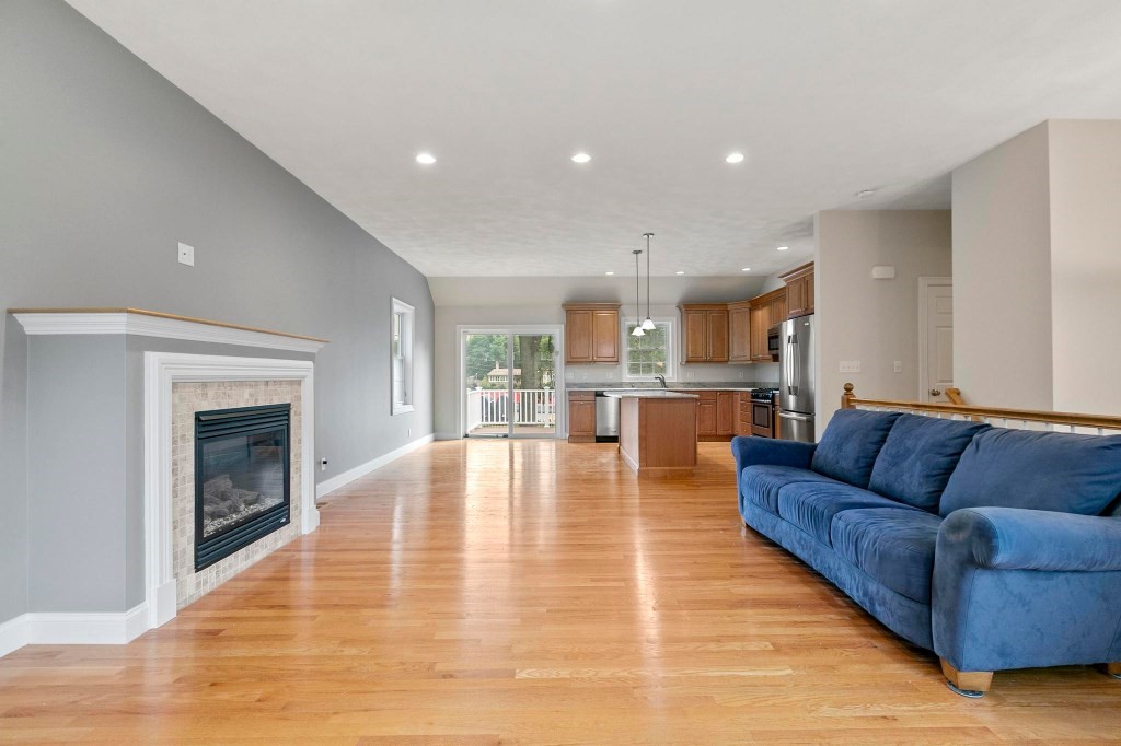 10 Emerald Court Stoneham, MA 02180 - Photo 12 of 42 a living room with furniture and a fireplace