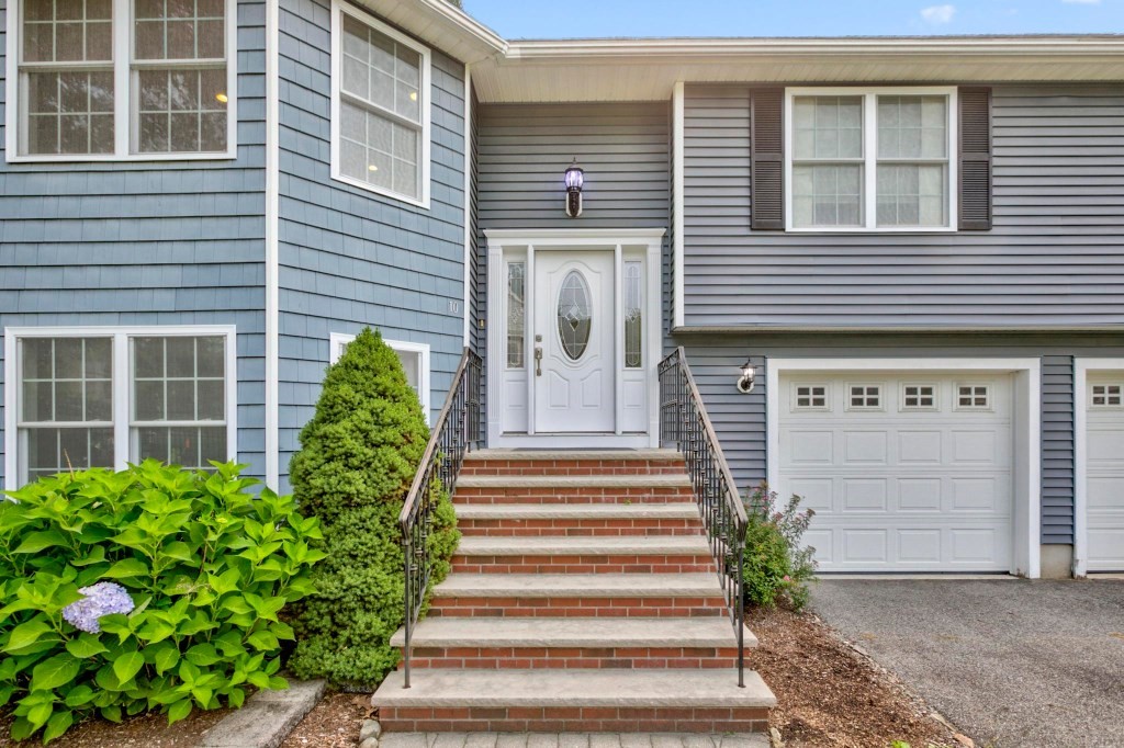 10 Emerald Court Stoneham, MA 02180 - Photo 25 of 42 a front view of a house with a garden