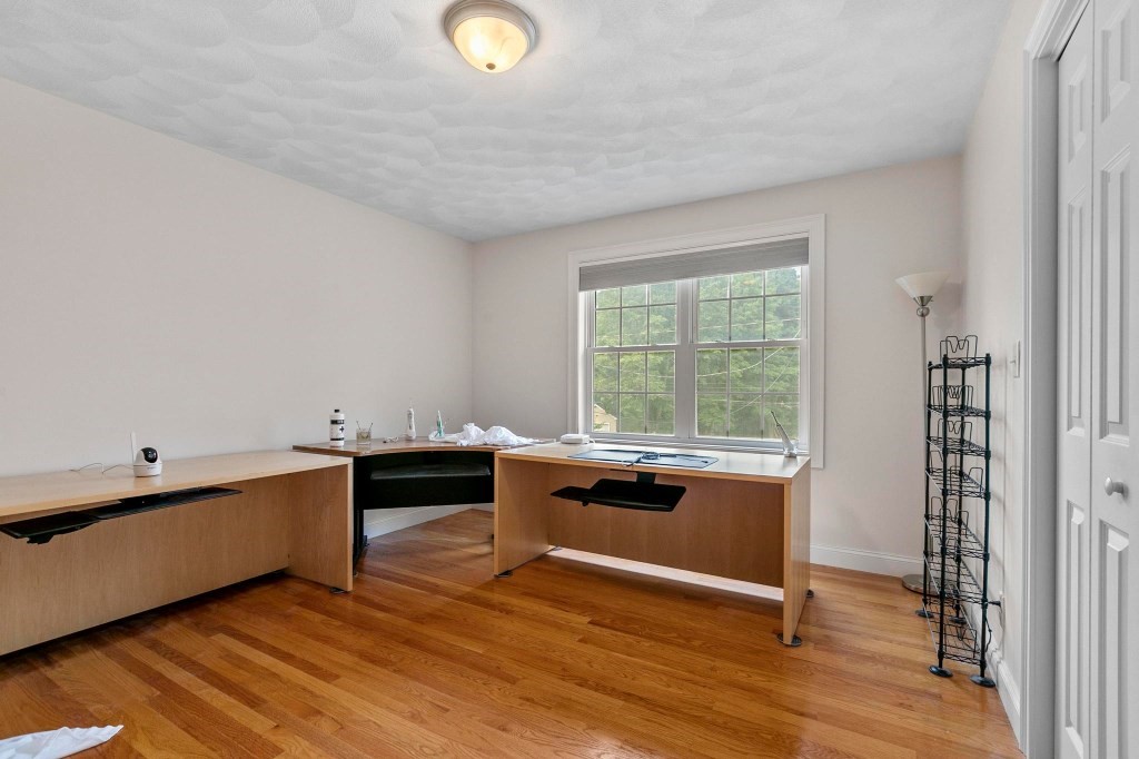 10 Emerald Court Stoneham, MA 02180 - Photo 26 of 42 a room with wooden floor and furniture