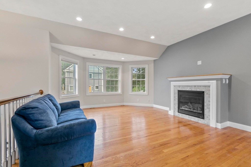10 Emerald Court Stoneham, MA 02180 - Photo 28 of 42 a living room with furniture and a fireplace