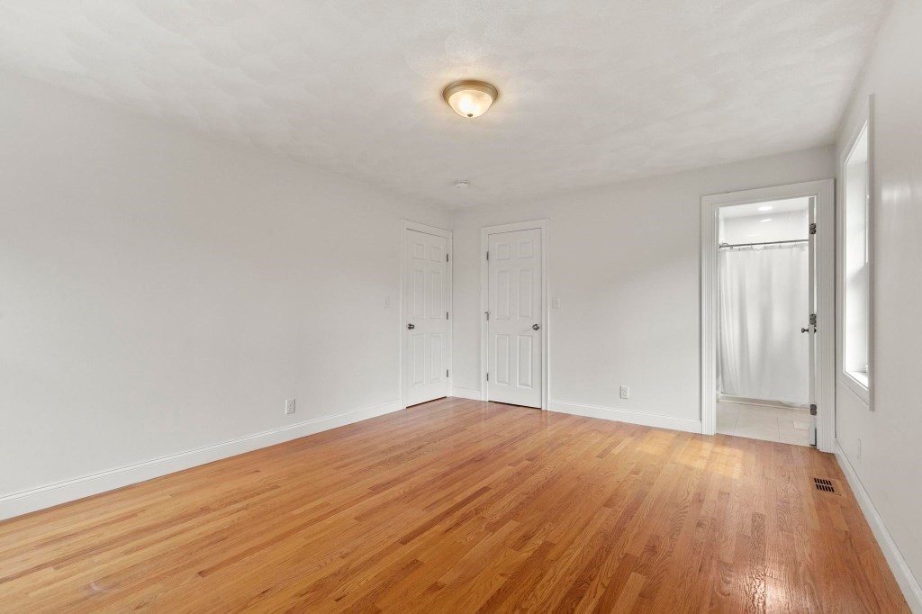 10 Emerald Court Stoneham, MA 02180 - Photo 33 of 42 a view of empty room with wooden floor and fan