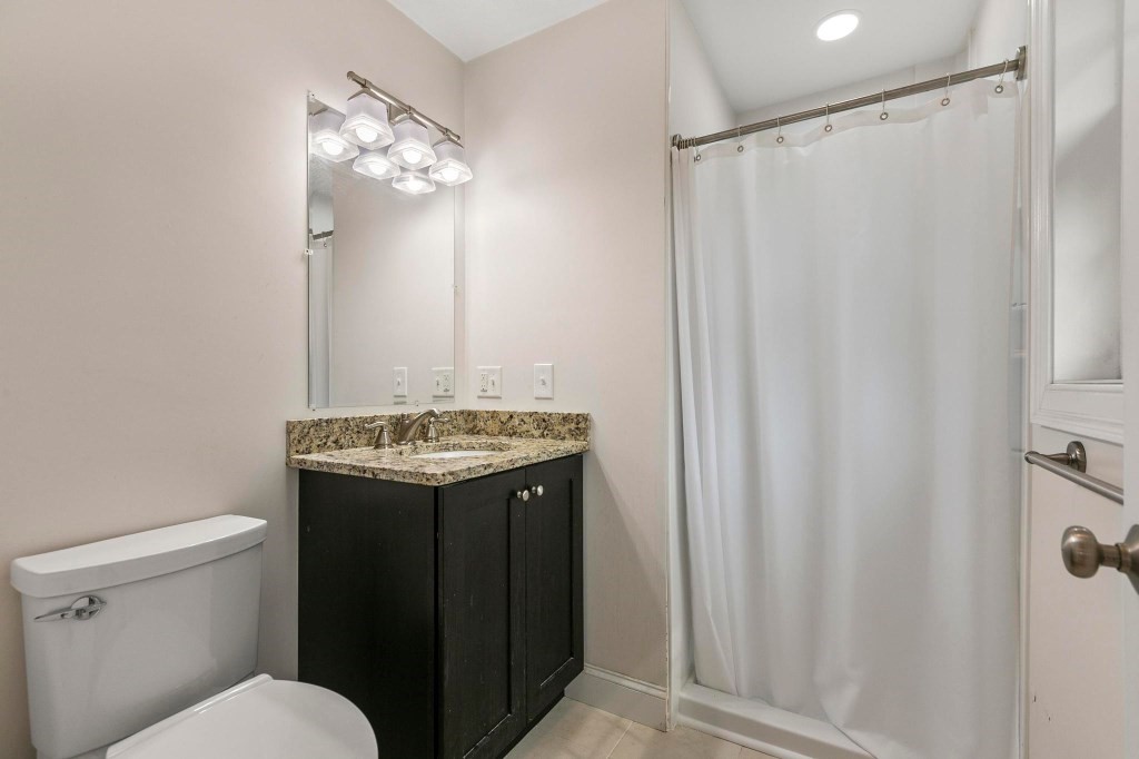 10 Emerald Court Stoneham, MA 02180 - Photo 35 of 42 a bathroom with a granite countertop sink toilet and shower
