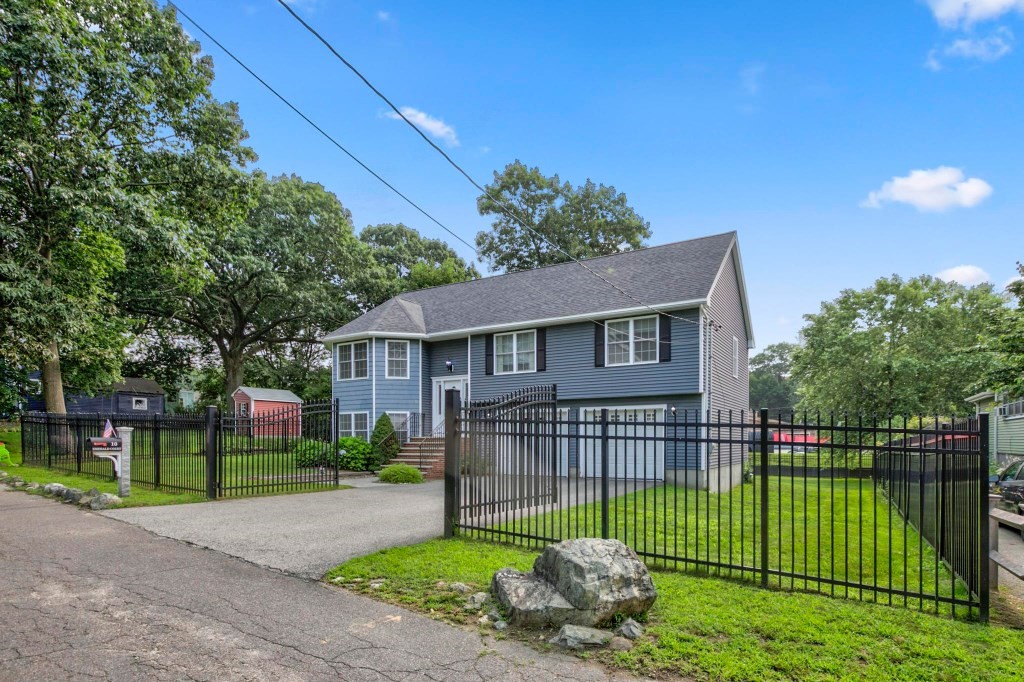 10 Emerald Court Stoneham, MA 02180 - Photo 6 of 42 a house that is sitting in middle of the middle of a park