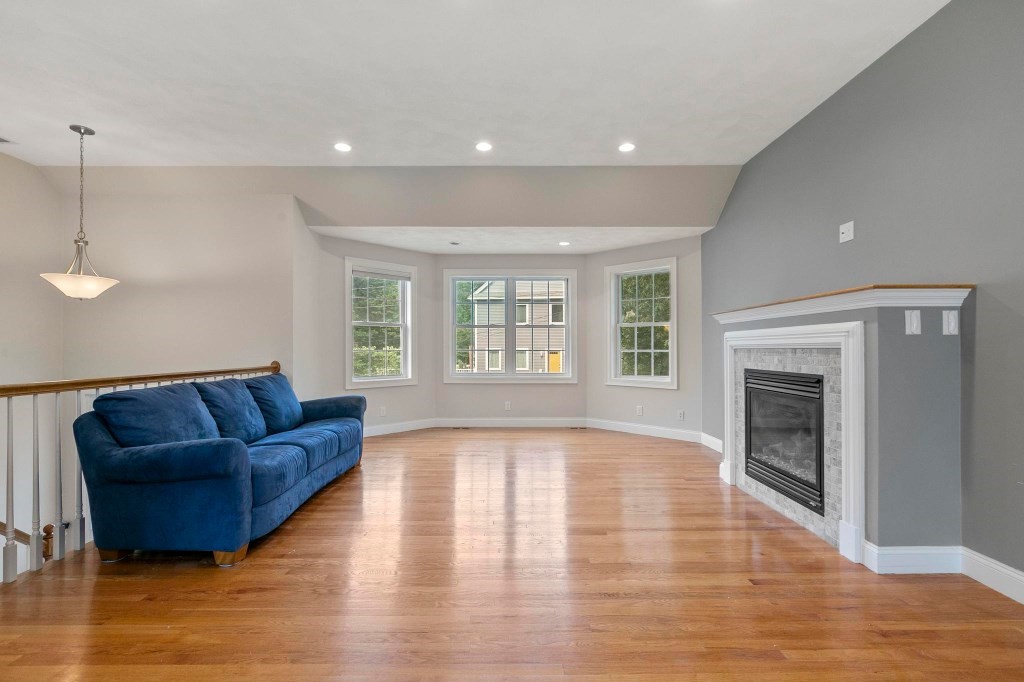 10 Emerald Court Stoneham, MA 02180 - Photo 10 of 42 a living room with furniture and a fireplace