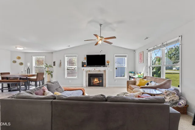 a living room with fireplace furniture and a flat screen tv