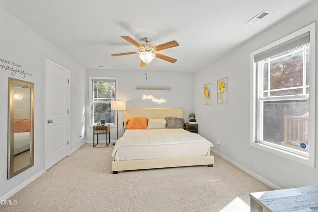 a bedroom with a bed couch and window