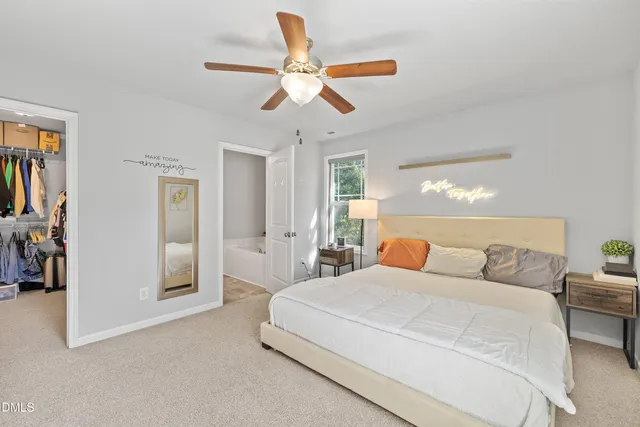 a bedroom with a large bed and a chandelier