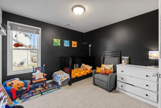 a bedroom with furniture and a window