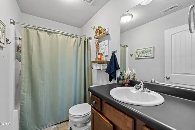 a bathroom with a sink toilet and a mirror