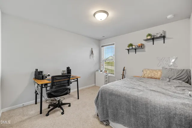 a bedroom with a bed and a desk