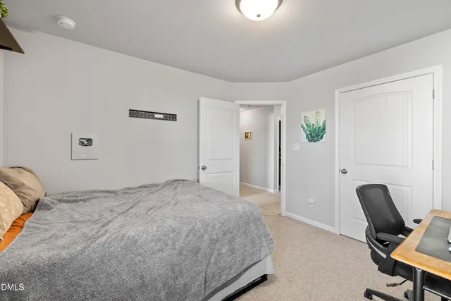 a bedroom with a bed and a chair