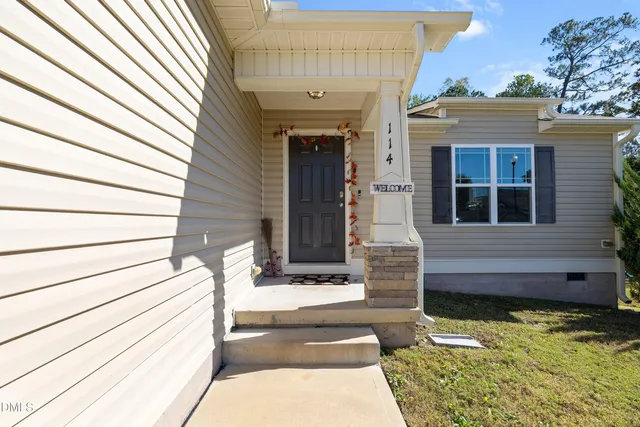 a front view of a house with stairs