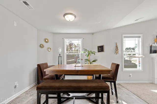 a view of a dining room with furniture and window