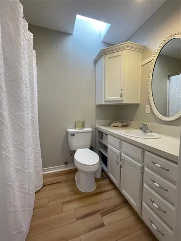 a bathroom with a toilet a sink and mirror